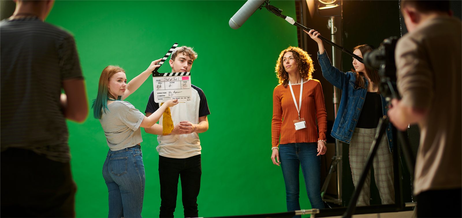 Students filming on a green-screen set